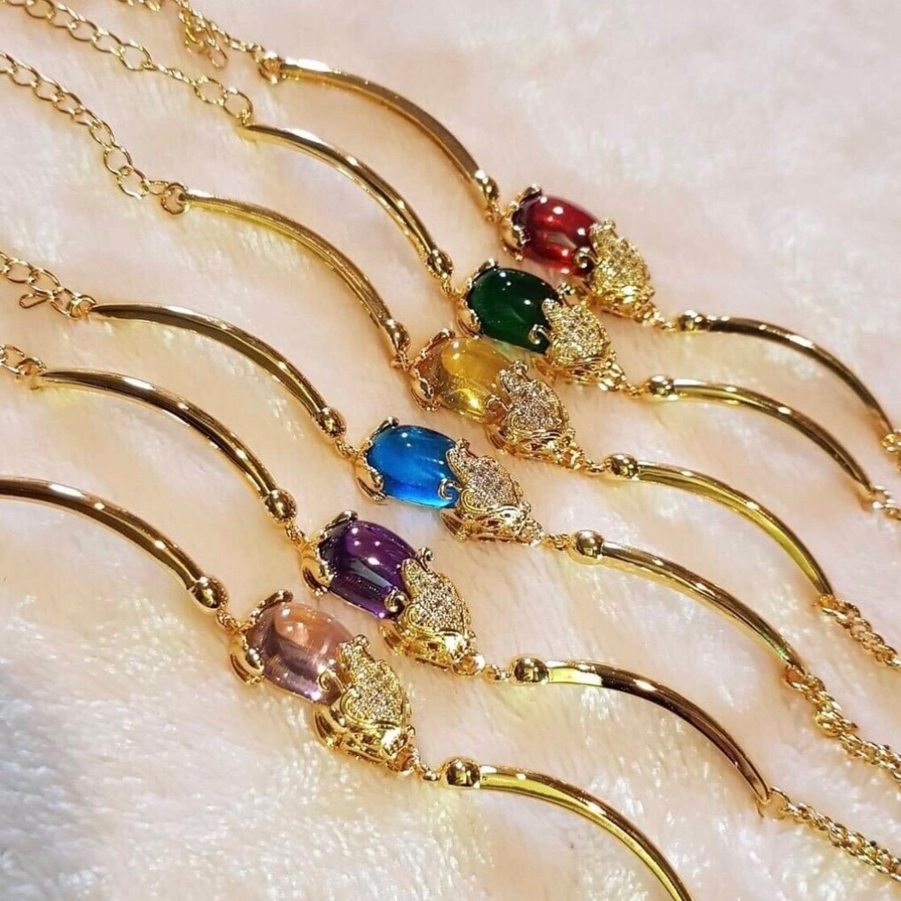 Gold plated bracelet  with purple stone.